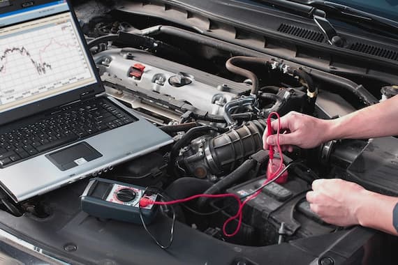 Mechanic working on vehicle in modern garage